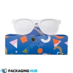 An open custom sunglasses box with a luxurious velvet interior holding a pair of sunglasses.